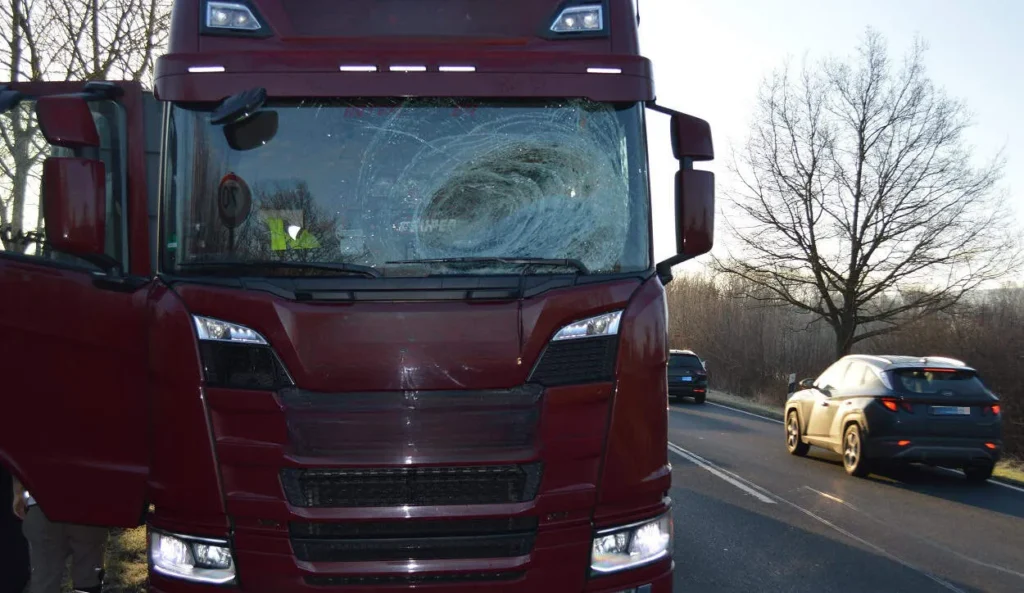 Lkw mit beschädigter Windschutzscheibe auf Straße.